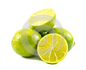 Three lemons and limes and one cut in half on a white background