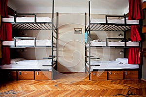 Three-level dormitory beds inside the hostel room for six