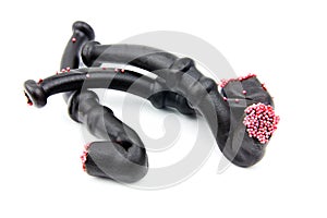 Three licorice pipes with red spheres