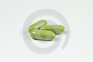 Three light green soft gelatine capsules.