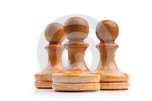 Three light wooden chess pieces alone isolated on white