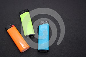 Three lighters on a black background