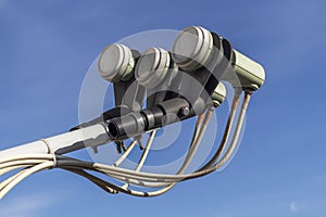 Three linear polarised LNB of a satellite dish closeup on blue sky background. Digital Video Broadcasting Ã¢â¬â Satellite. photo