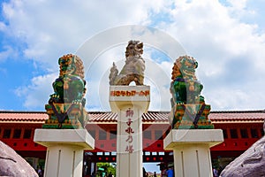 Three Japanese lion statues.