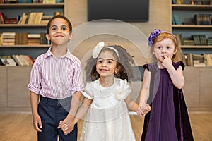 Three little children in celebratory clothes