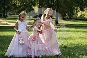 Three little cute bridesmaids with bubble