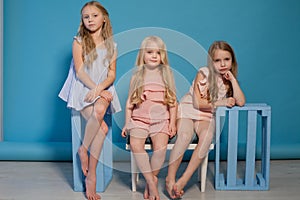 Three little girls girlfriend sit together portrait