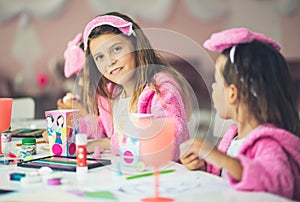 Three little girls having a party at home. Kids playing and drawing