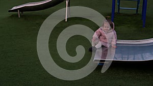 Three little Happy Children having fun Sliding. Smiling Funny Siblings friends playing outside. emotional kids rides on
