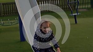 Three little Happy Children having fun Sliding. Smiling Funny Siblings friends playing outside. emotional kids rides on