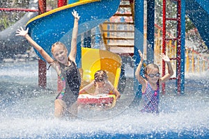 Three little kids playing in the swimming pool