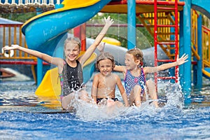 Three little kids playing in the swimming pool