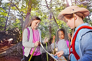 Three little kids reading orientation map