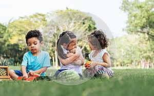 Three little mixed race kids consist of African and caucasian boys and girls smiling with happiness, fun amusement, playing,