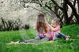 Three little sisters having a lot of fun playing together outdoor in summer park on vacation photo