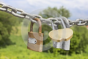 Three locks on a thick galvanized chain