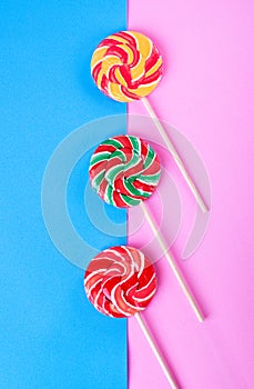 Three lollipops on pink and blue