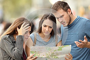 Three lost tourists trying to find a location in a map photo