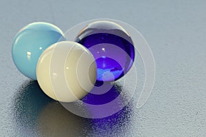 Three lovely coloured marbles on black surface - stock photo