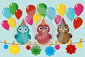 Three lovely owls sit on a rope and hold balloons.