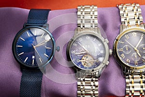 Three luxury sport Matteo Ferari male watches on bronze background photo