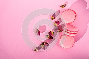 Three Macaron in a stack. French pasta on a pink background.