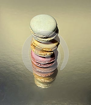 Three macaroons pink, blue, yellow lying on each other