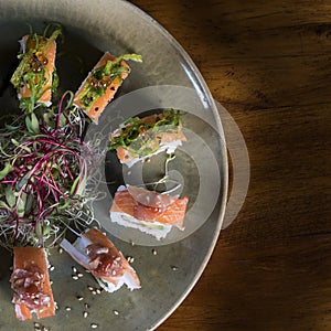 Three maki rolls in a row with salmon, eel and cucumber isolated on white background. Fresh hosomaki pieces with rice