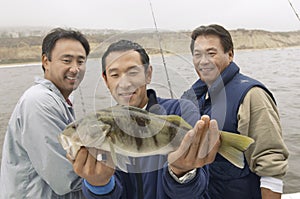 Three Male Friends With A Catch