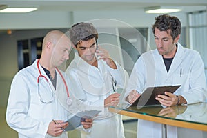 Three male medics conferring