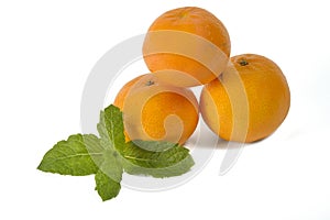 Three mandarins with a piece of mint