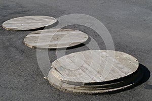 Three Manhole Covers