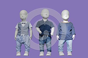 Three mannequins dressed in fashionable kids wear
