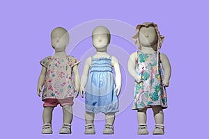 Three mannequins dressed in kids wear