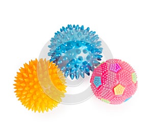 Three massage rubber balls with thorns pink, blue, yellow isol