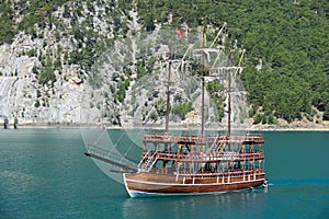 A three-masted tourist yacht sails on the lake near the Oymapinar dam. Green canyon, Manavgat, Antalya, Turkey