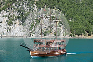 A three-masted tourist yacht sails on the lake near the Oymapinar dam. Green canyon, Manavgat, Antalya, Turkey