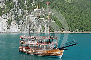 A three-masted tourist yacht sails on the lake near the Oymapinar dam. Green canyon, Manavgat, Antalya, Turkey