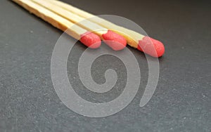 Three matchsticks over black background. Closeup of matchsticks.