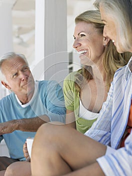 Three Mature People Sitting On Verandah