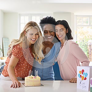 Three Mature Women Meeting At Home To Celebrate Friend\'s Birthday With Surprise Cake Together