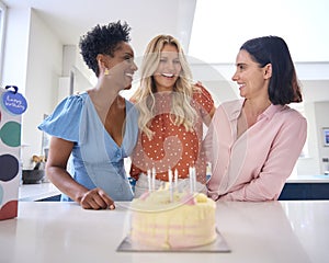 Three Mature Women Meeting At Home To Celebrate Friend\'s Birthday With Surprise Cake Together