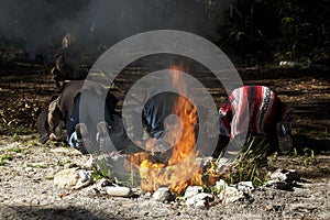 Three mayan priests bowing in prayer