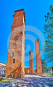 Three medieval towers on Piazza Leonardo da Vinci in Pavia, Italy