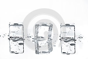 Three melting Ice cubes with Reflections on White