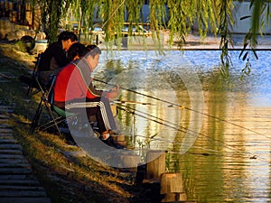 Three men fishing in lake