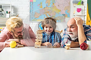 Three men generation. Excited teach. Happy multi generation family playing Jenga together at home.