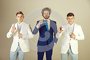 Three men holding blank cards