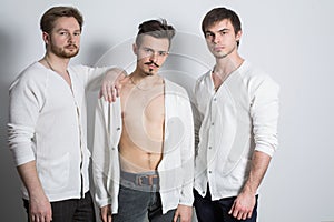 Three men in a white cardigan over his naked body