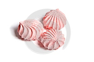 Three Meringue cookies. Pink Meringues kisses isolated on white background